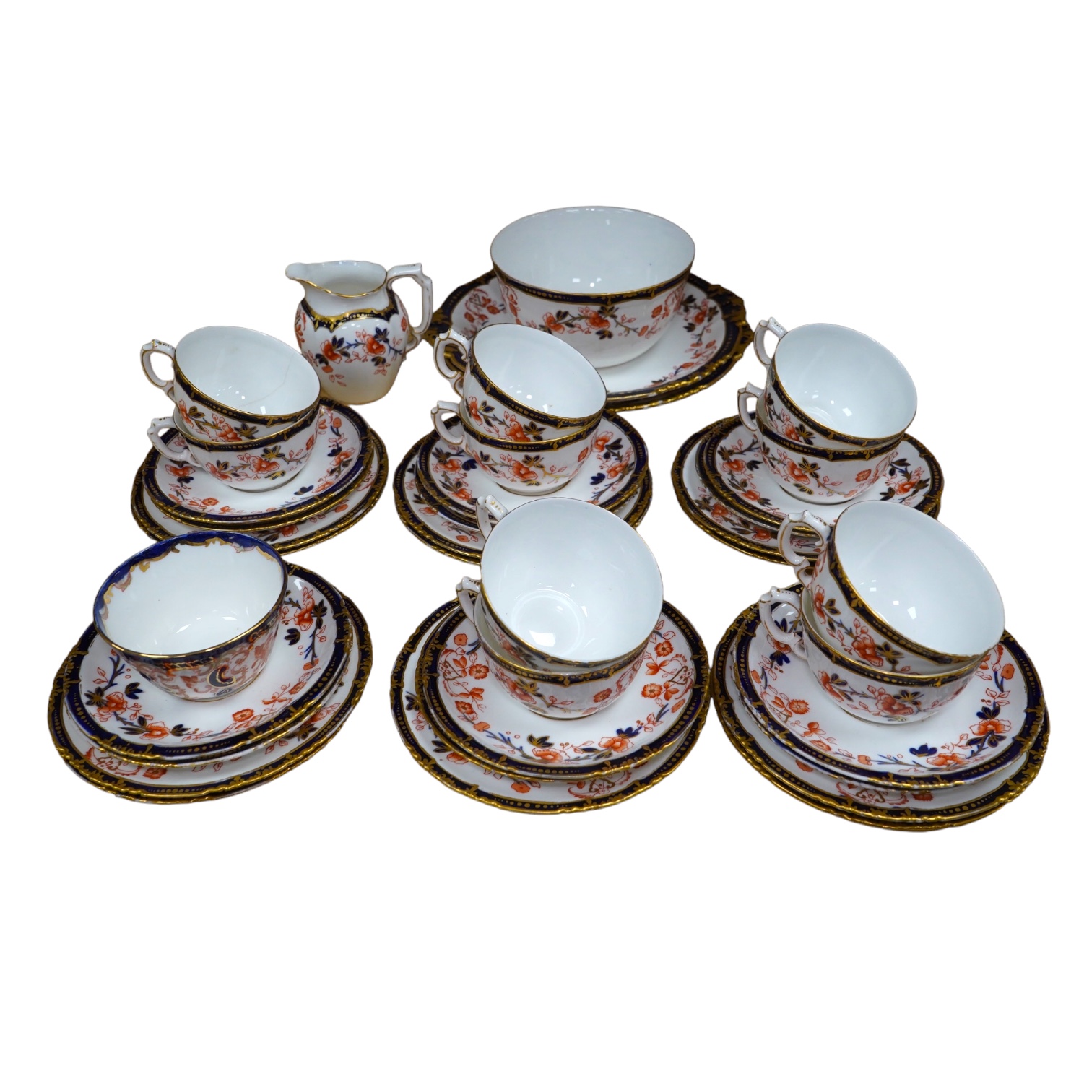 A Royal Crown Derby Imari porcelain part tea set to include sandwich plates, trios and milk jug. Condition - varies, some breaks